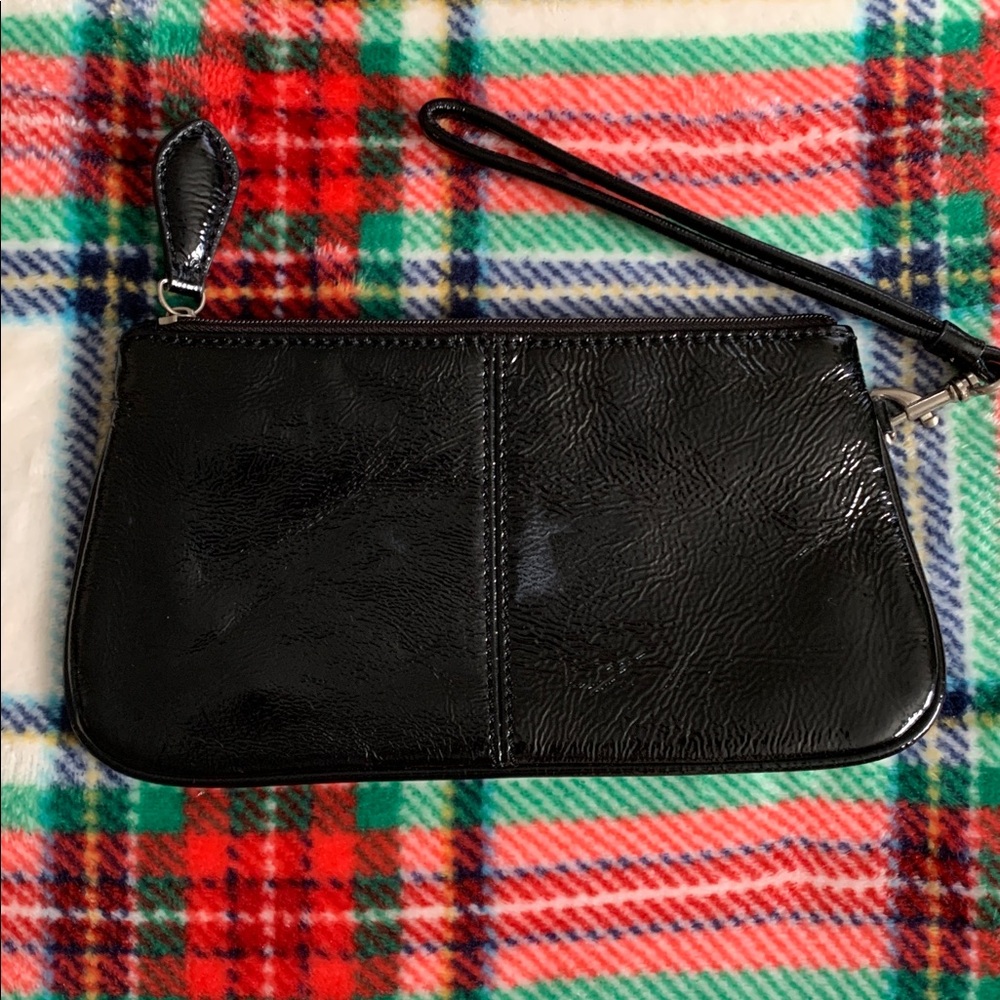 Wilsons Leather black patent leather wristlet clutch
Approximately 8”x4”
Pretty!